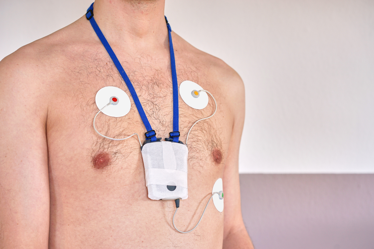 Man wearing 24 hrs electrocardiogram monitor device on his chest